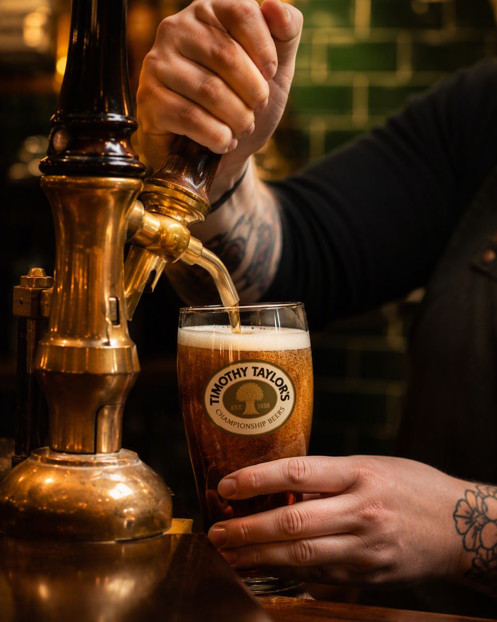 A pint of cask ale being poured at the bar